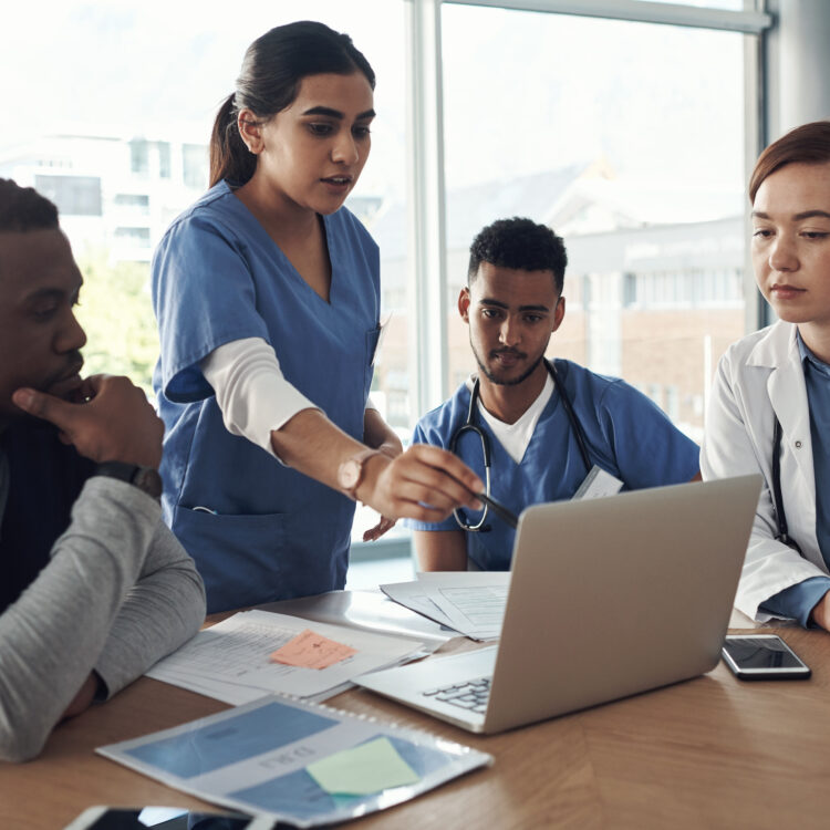 Shot a group of doctors discussing work matters in the office at work.